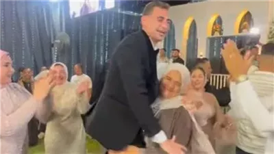 عريس يكشف كواليس فيديو زوجة عمه وهي تحمله في حفل زفافه: «في مقام أمي»